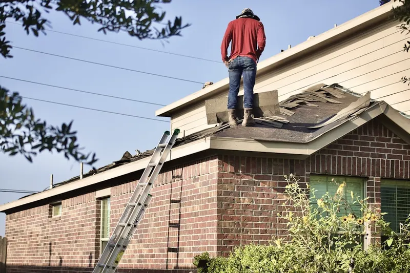 Professional roofer working on a residential roof in Holdingford